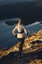 Trail running in autumn on the Jochberg on Lake Walchensee against the wonderful backdrop of the