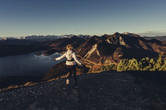 Trail running in autumn on the Jochberg on Lake Walchensee against the wonderful backdrop of the