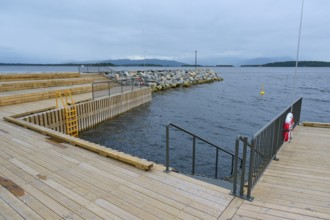 Outdoor sea pool by the fjord, overcast sky and calm water, Molde, Romsdal, Norway, Europe