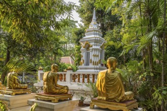 Golden statues of monks in the garden of the Buddhist temple complex Wat Phra Singh, Chiang Mai,