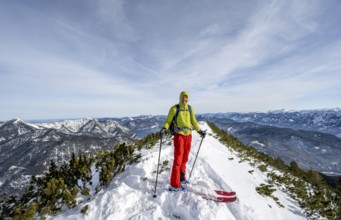 Ski tourer at the summit of Simetsberg, mountain panorama, Estergebirge, Bavarian Prealps, Bavaria