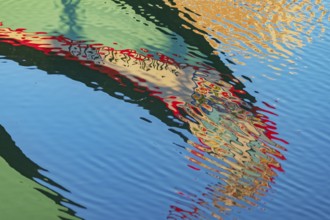 Traditional Moliceiro boat reflected in the water, Aveiro, Portugal, Europe