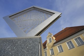 Square stainless steel sculpture with louvres and art museum built in 1785 with tail gable,