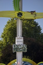 An employee works at the Chaos Pendulum ride at a dizzying height, Cranger Kirmes, Herne, Ruhr