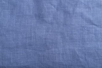 Fragment of smooth blue linen tissue. Top view, flat lay, natural textile background and texture