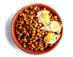 Fried chickpeas with quail eggs and spices in a clay plate isolated on white background, top view