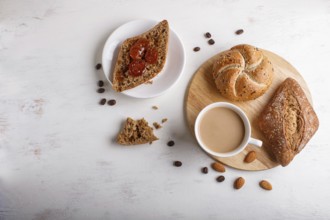 Cup of coffee with cream and buns on a white wooden background. top view, flat lay, copy space