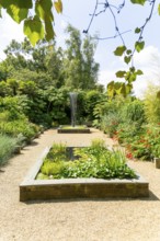 Exotic garden with fountain sculpture by Gile Raynor, East Ruston Old Vicarage garden, East Ruston,