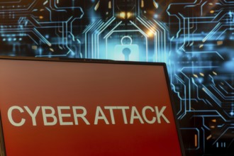 Cyber attack symbol: Laptop in front of a virtual computer background