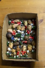 Plastic models of football players in cardboard box, UK