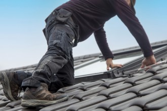 Roofer installing a new roof window