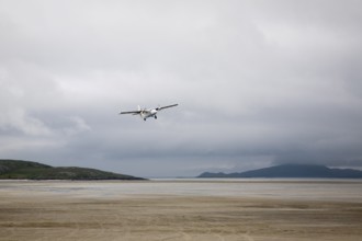 Flybe plane taking off from sandy airstrip Isle of Barra airport, Barra, Outer Hebrides, Scotland,