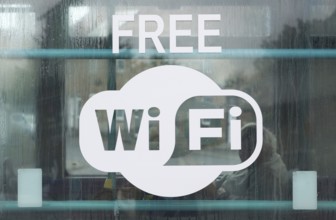 Sign for Free Wi Fi on glass window public transport bus, Suffolk, England, UK