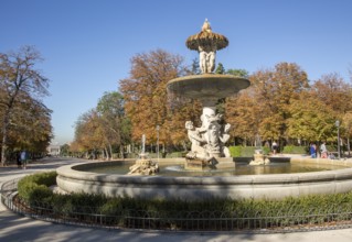 People walking by monument fountain in El Retiro park, Madrid, Spain, Europe