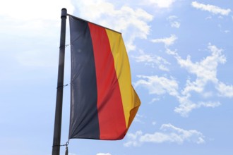 German national flag in front of a blue sky