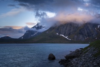 Mountain landscape on the Lofoten Islands. View over the sea to a mountain, the summit is in the