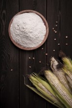 Corn cobs, corn flour, on a wooden table, top view, close-up, rustic, selective focus, dairy corn