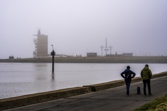 Thick fog in winter, hanging over the mouth of the Elbe into the North Sea, radar tower of the