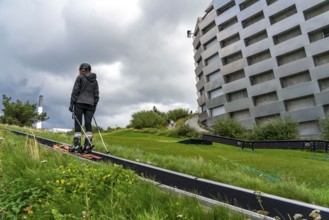 CopenHill, waste incineration plant and artificial ski slope, skiing with a view of the ski lift,