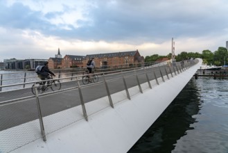 Cyclists on the Lille Langebro cycle and pedestrian bridge over the harbour, Copenhagen is