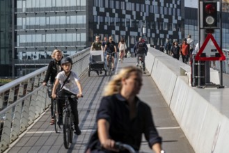 Cyclists on the Bryggebroen cycle and footpath bridge over the harbour, Sydhavnen, Copenhagen is