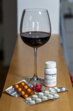 Symbolic image of alcohol and medication, you should not take medicine, pills, tablets with