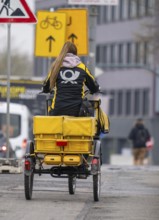 Deutsche Post delivery woman on an electric post tricycle