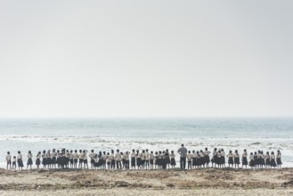 Large school class, children in school uniform and teacher on the beach, Fort Cochin, Kochi,