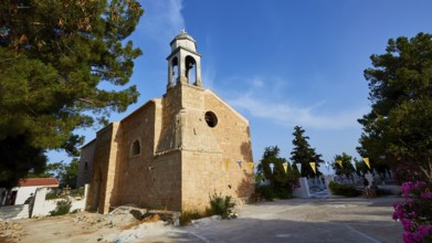 A traditional church with bell tower and blue sky in the background, Koroni, Byzantine fortress,