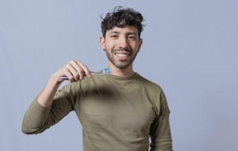 Close up of man holding a dental brush isolated, Handsome man holding dental brush. Tooth brushing