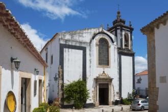 Baroque church with magnificent bell tower and blue sky, Church Igreja de São Pedro, Óbidos,