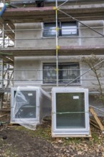 Energy renovation of a residential building, new windows waiting to be installed, on a building