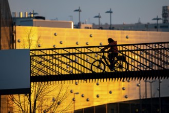 Cyclist on a bridge over Segerothstraße, in Essen, behind Limbecker Platz shopping centre