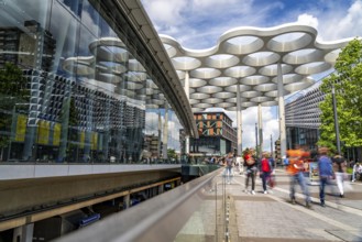 Station forecourt of Utrecht Centraal station, people on their way to, from the station,