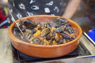 Paella preparation at the street market in Las Ramblas near Barcelona Cathedral square