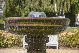 Fountain with falling drops of water in the rose garden park in Bad Salzuflen, Lippe district,