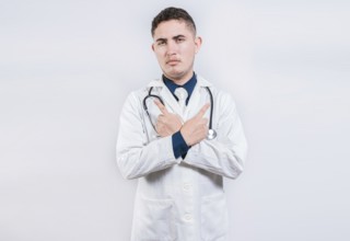 Doctor pointing at an advertising space with both hands. Doctor pointing to both sides isolated.