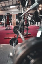 A view of a weight bar with weights on it in a modern fitness studio, Historic Fitness Studio,