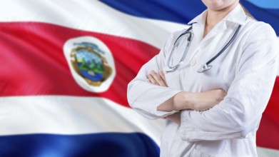 Healthcare concept with Costa Rica flag in background. Female doctor with crossed arms with Costa