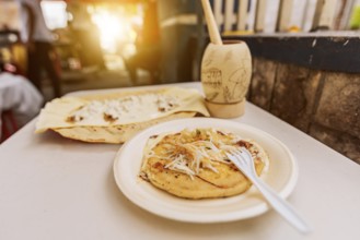 Traditional pupusa with Quesillo served on the table. Quesillo with pupusa served on the table with