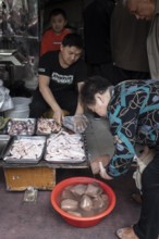 Stall selling duck giblets, including dried duck blood, an inexpensive foodstuff that is very