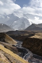 Achik Tash river, Achik Tash valley, behind glaciated and snow-covered mountain peak Pik Lenin,