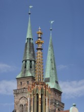 Spire of the Beautiful Fountain, behind the towers of St Sebald's Church, Main Market Square,