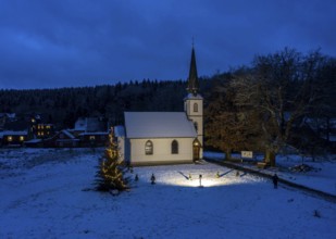 A Christmas tree stands in front of the smallest wooden church in Germany, Elend, 29 December 2020