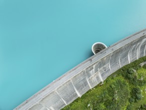 Dam of the Moiry lake, Lac de Moiry, turquoise glacial water, water overflow, tourists, aerial