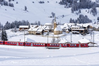 Rhaetian Railway train on the Albula railway Passenger train in the Alps in Bergün, Switzerland,