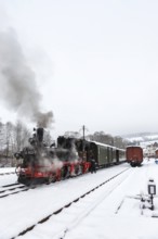 Steam train of the Preßnitztalbahn railway Steam locomotive in winter in Steinbach, Germany, Europe