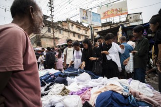 People buys clothes at a street market ahead of Durga Puja festival on October 7, 2024 in Guwahati,