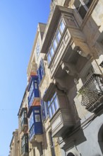 Balconies of houses historic street in city centre of Valletta, Malta, Europe