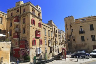 Red telephone box booth in historic city centre of Valletta, Malta, Europe